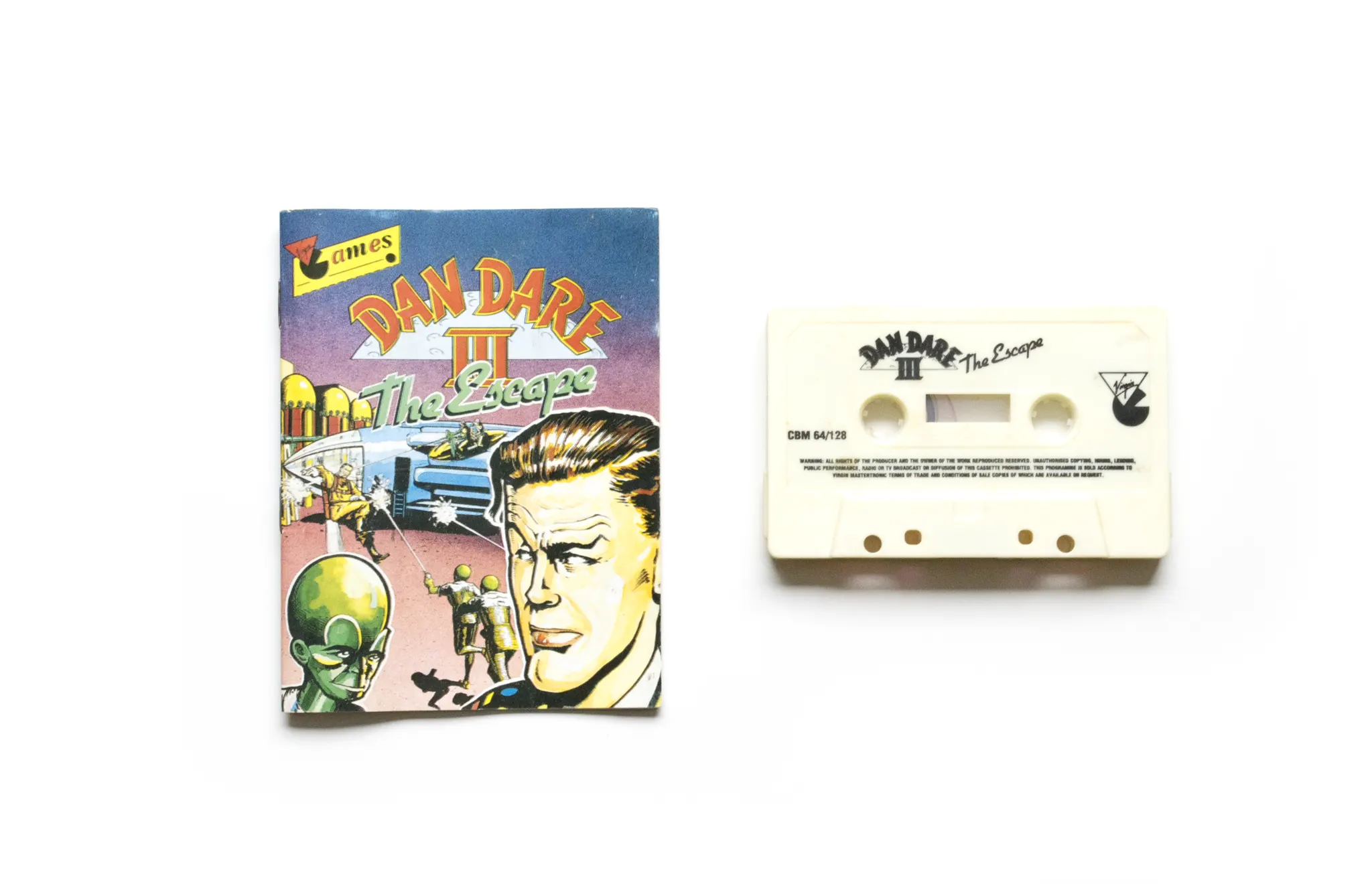 Photo of the content of Dan Dare III: The Escape (1990, C64, EU); developed by Probe Software Ltd., published by Virgin Mastertronic Ltd.; Hi-res 3D box available at https://bigboxcollection.com