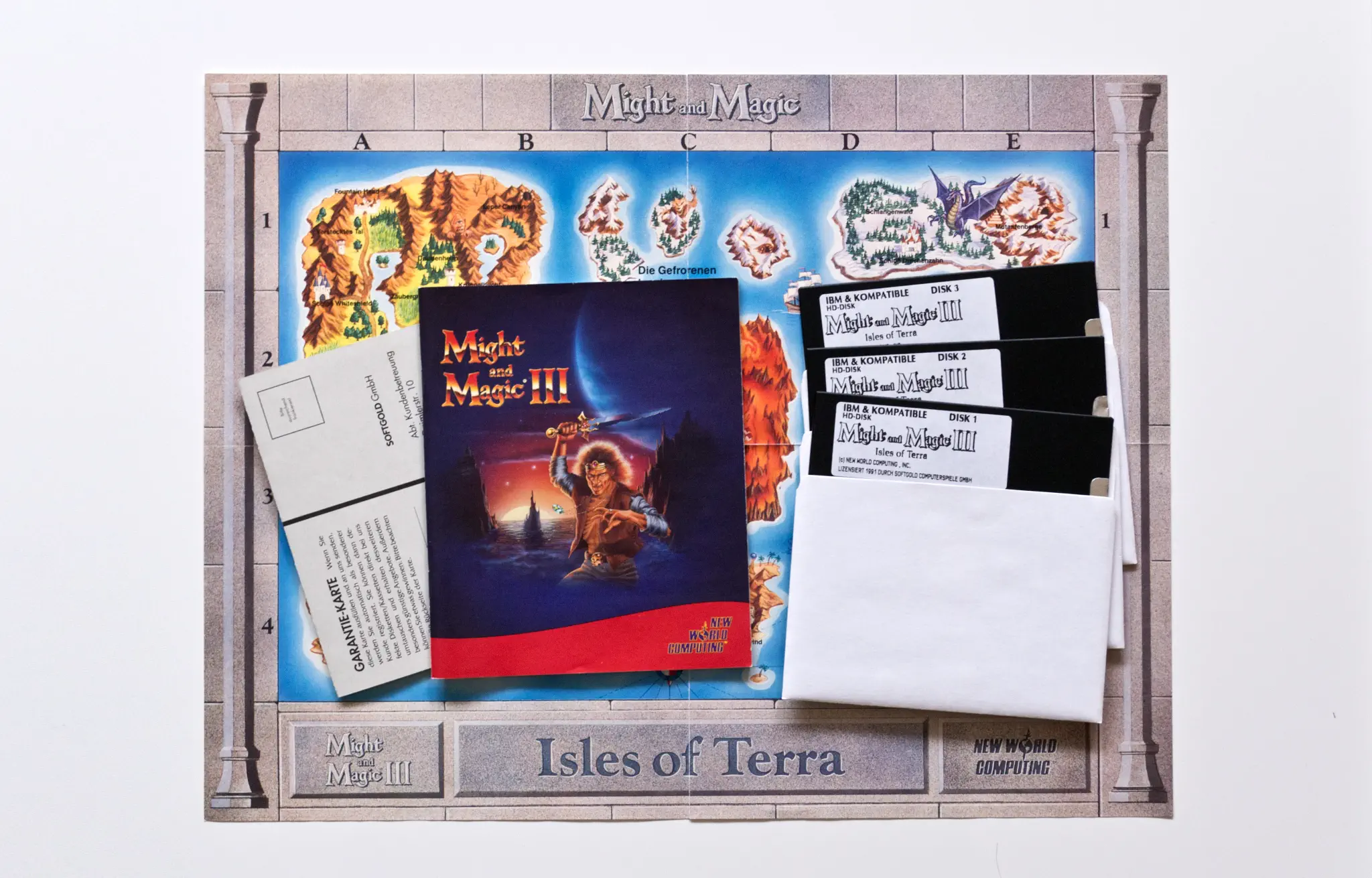 Photo of the content of Might and Magic III: Isles of Terra (1991, PC, DE); developed by New World Computing Inc., published by Softgold Computerspiele GmbH; Hi-res 3D box available at https://bigboxcollection.com