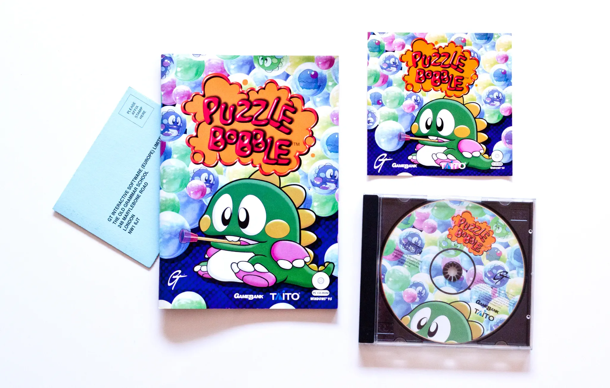 Photo of the content of Puzzle Bobble (1995, PC, EU) Photo of the content of Puzzle Bobble (1995, PC, EU); developed by Taito Corporation, published by GameBank Corp.; Hi-res 3D box available at https://bigboxcollection.com