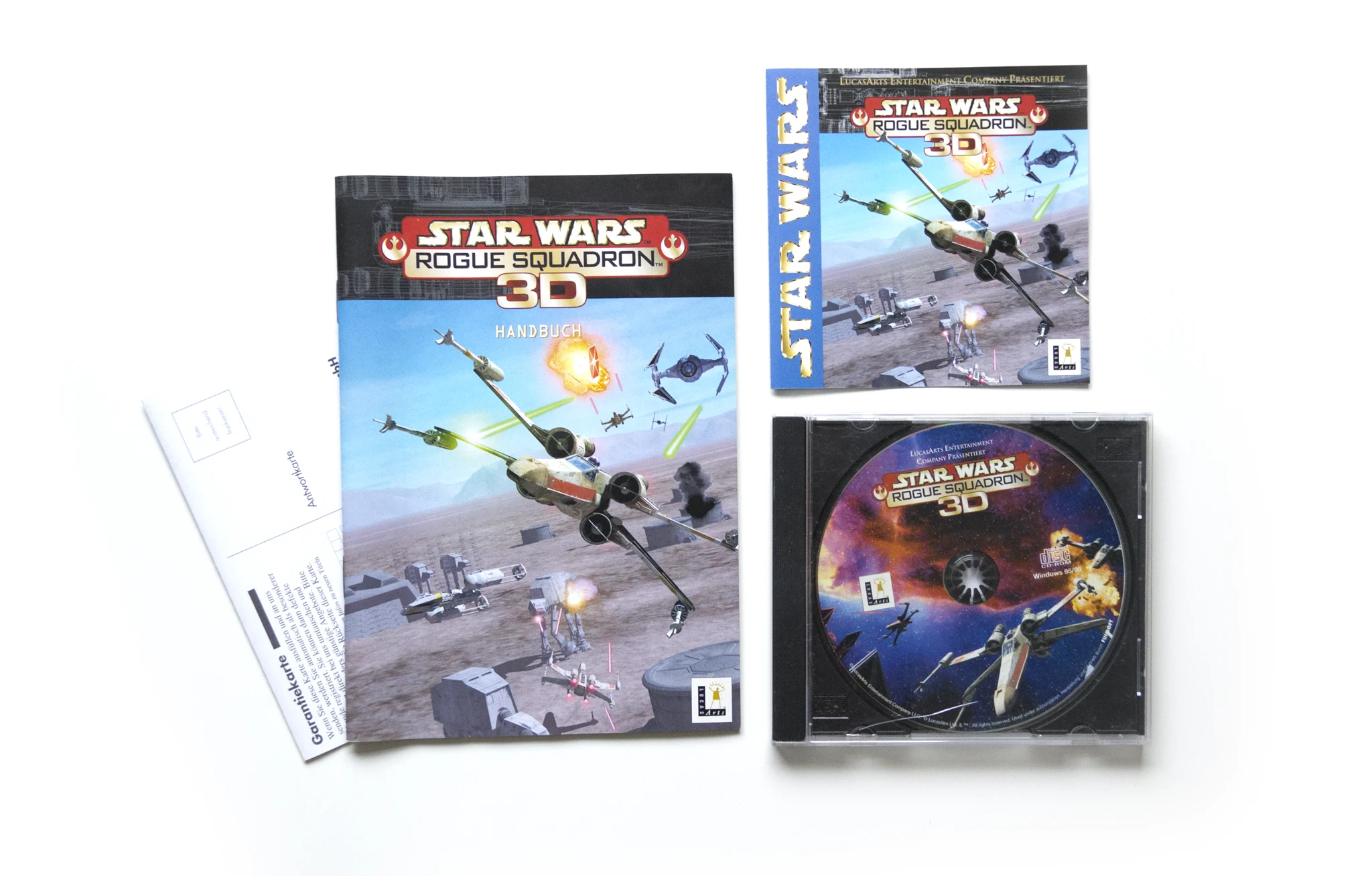 Photo of the content of Star Wars: Rogue Squadron 3D (1999, PC, DE); developed by Factor 5 GmbH, LucasArts Entertainment Company LLC, published by Funsoft GmbH; Hi-res 3D box available at https://bigboxcollection.com