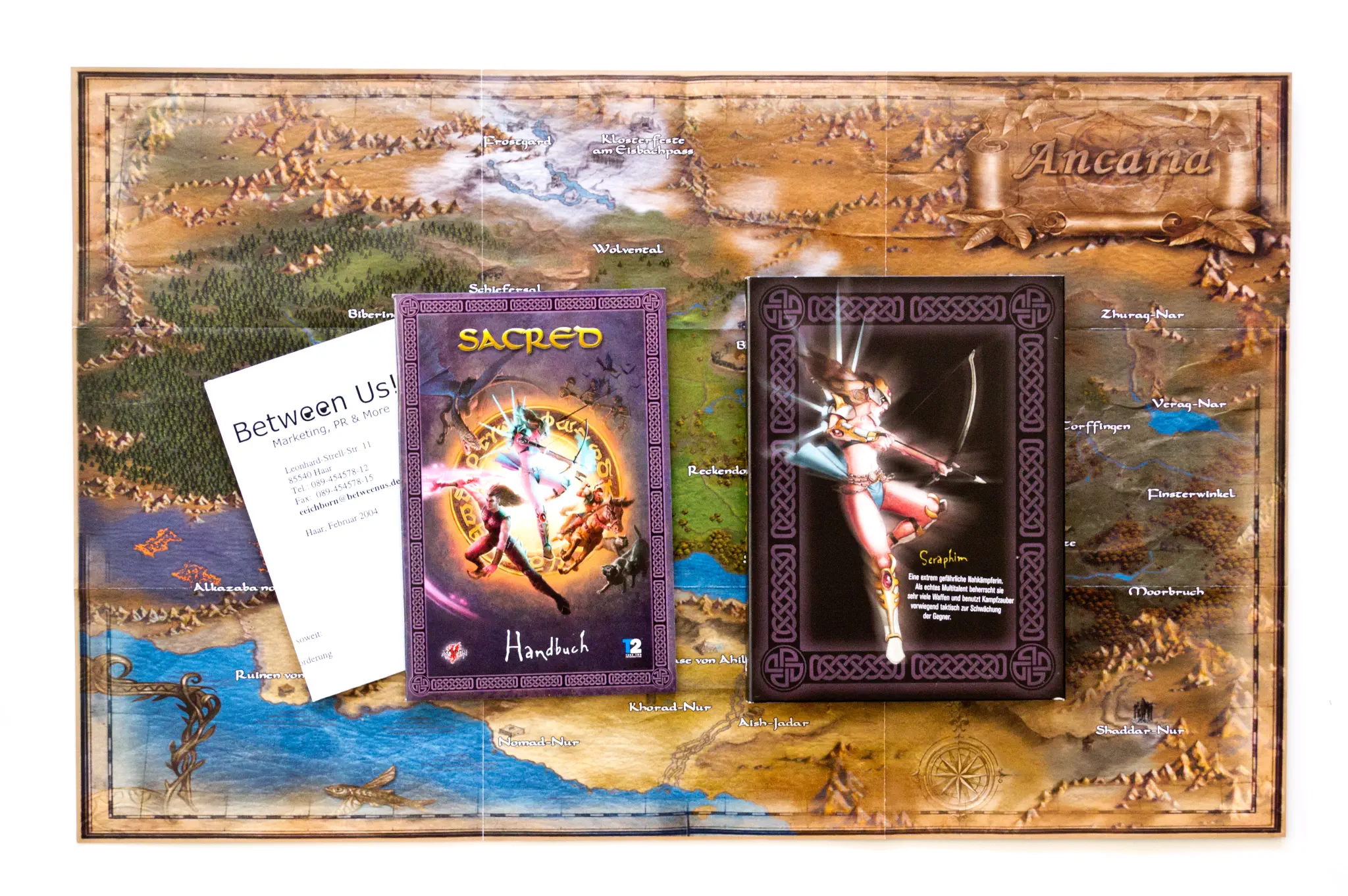 Photo of the content of Sacred (2004, PC, DE) Photo of the content of Sacred (2004, PC, DE); developed by Studio II Software GmbH, published by Take-Two Interactive Software, Inc.; Hi-res 3D box available at https://bigboxcollection.com