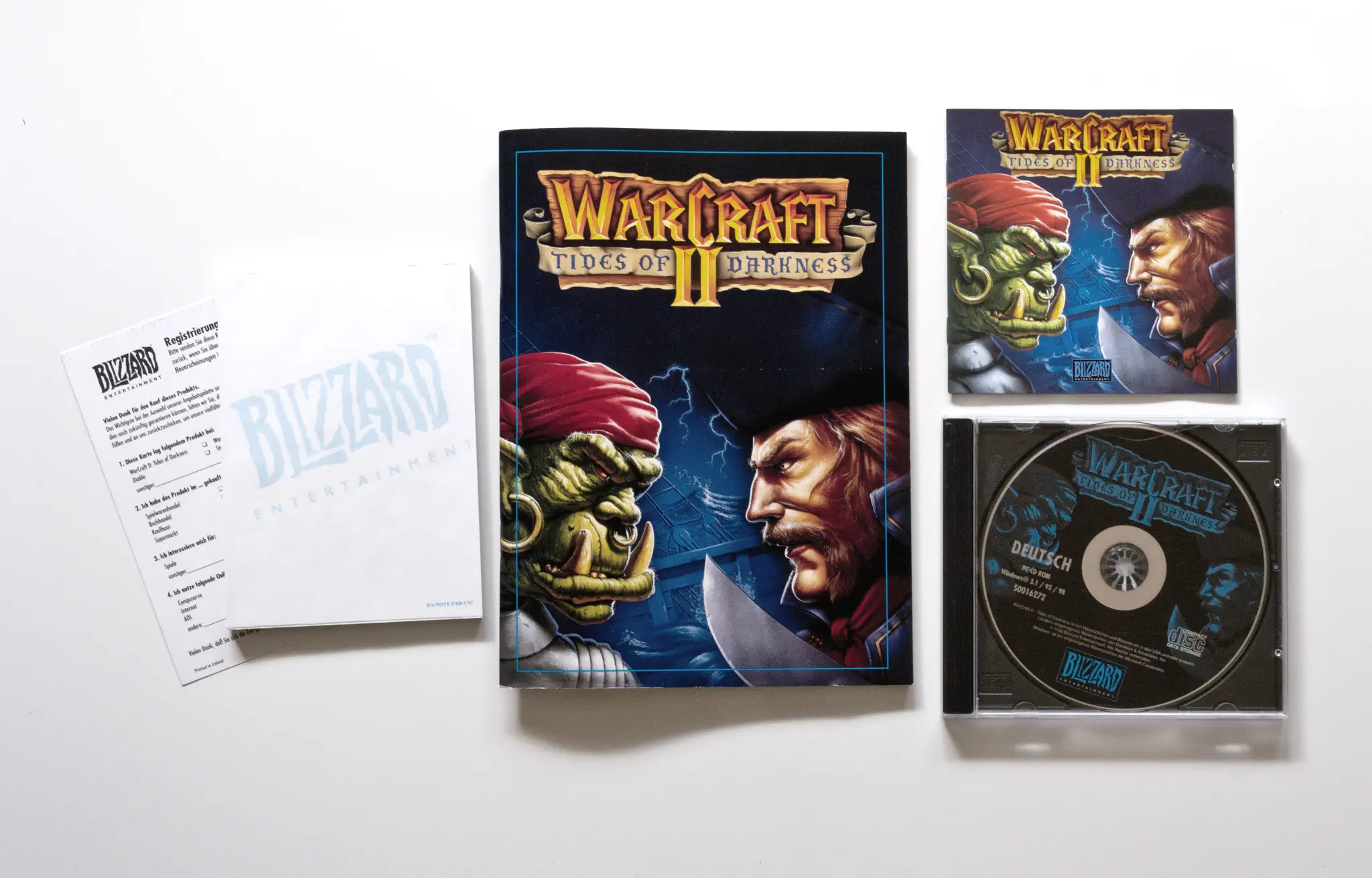 Photo of the content of WarCraft II: Tides of Darkness (1995, PC, DE); developed by Blizzard Entertainment Inc., published by Blizzard Entertainment Inc.; Hi-res 3D box available at https://bigboxcollection.com